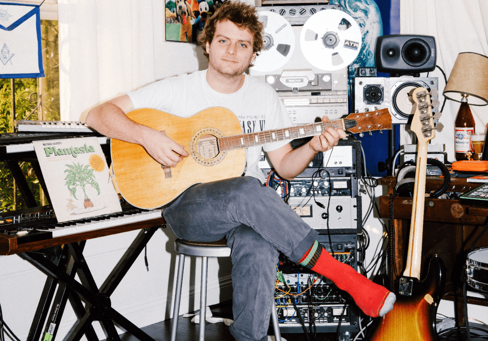 A color photo of Mac DeMarco in his home studio.