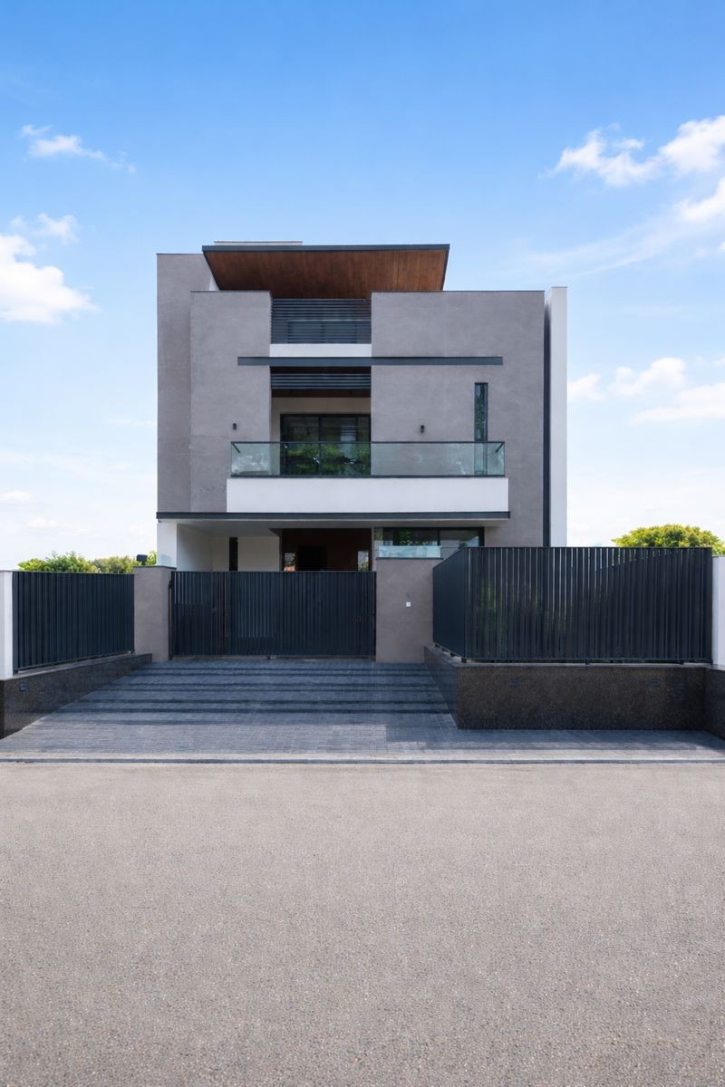Modern timber-clad residence with horizontal wood facade and geometric volumes set on manicured lawn