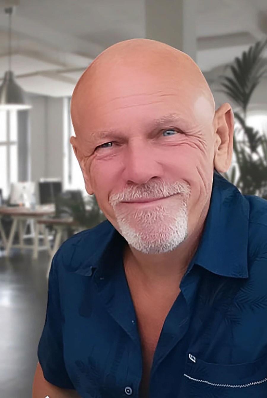 Portrait of Salon Guru founder Phil Evans smiling in an office setting.