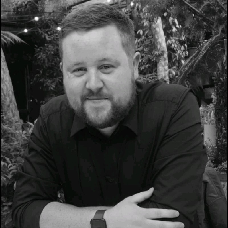 man in gray polo shirt smiling