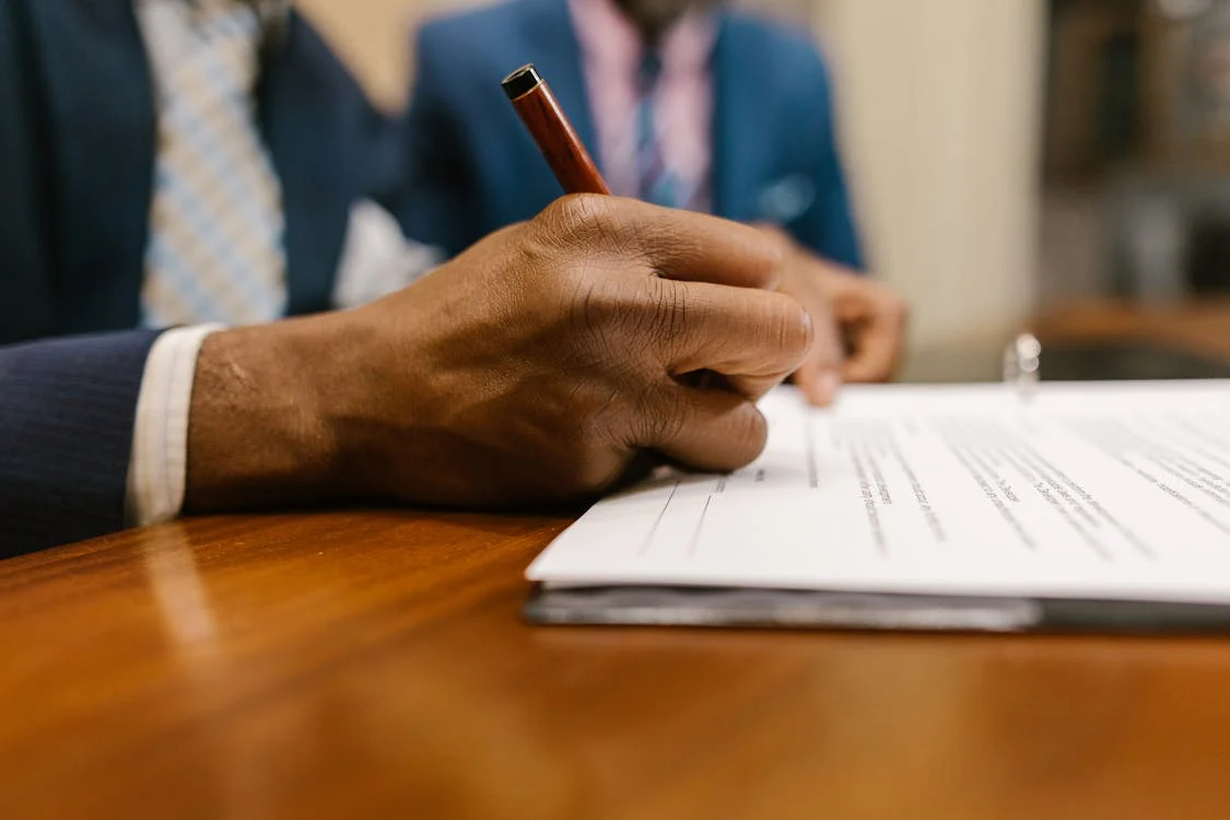 man sitting beside woman looking at a contract on DocuSign