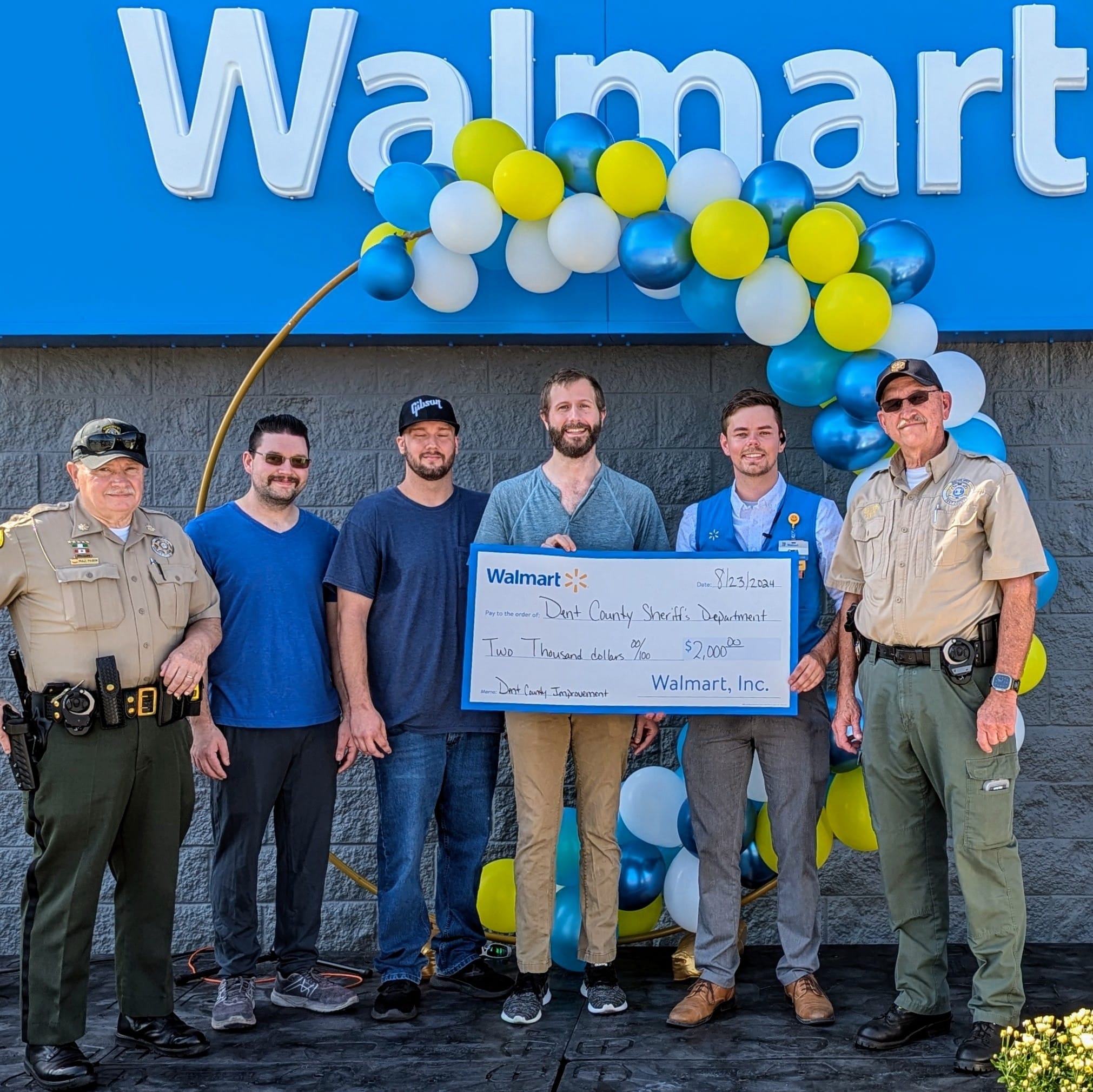 woman in black blazer covering her face with her hand