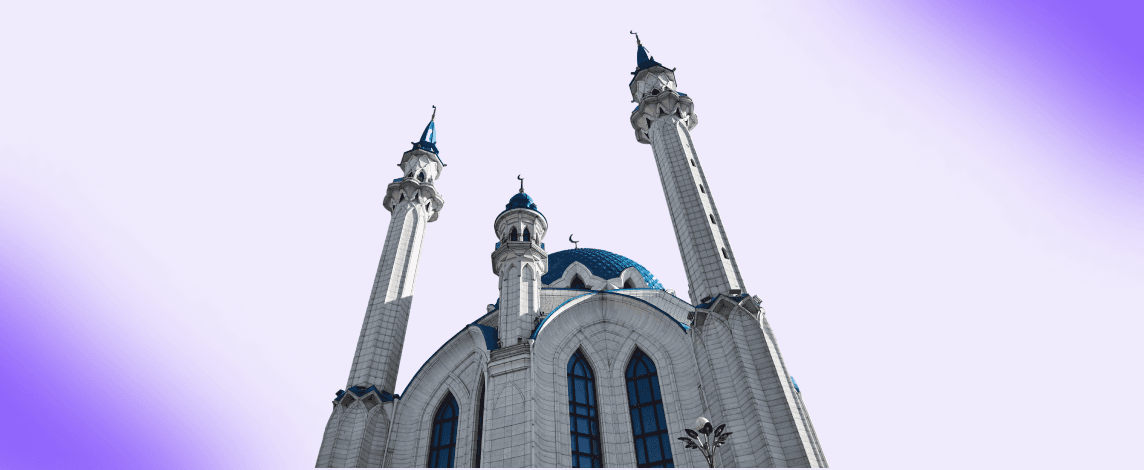 Elegant mosque with soaring minarets and a blue dome against a clear sky, representing the place of worship for the Friday Jummah prayer.