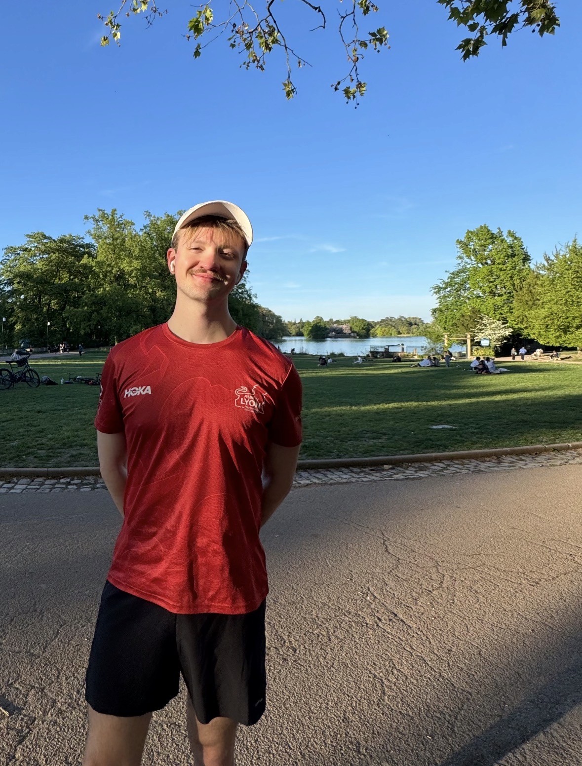 Three individuals gathered around a table, engaged in discussion while examining a laptop.