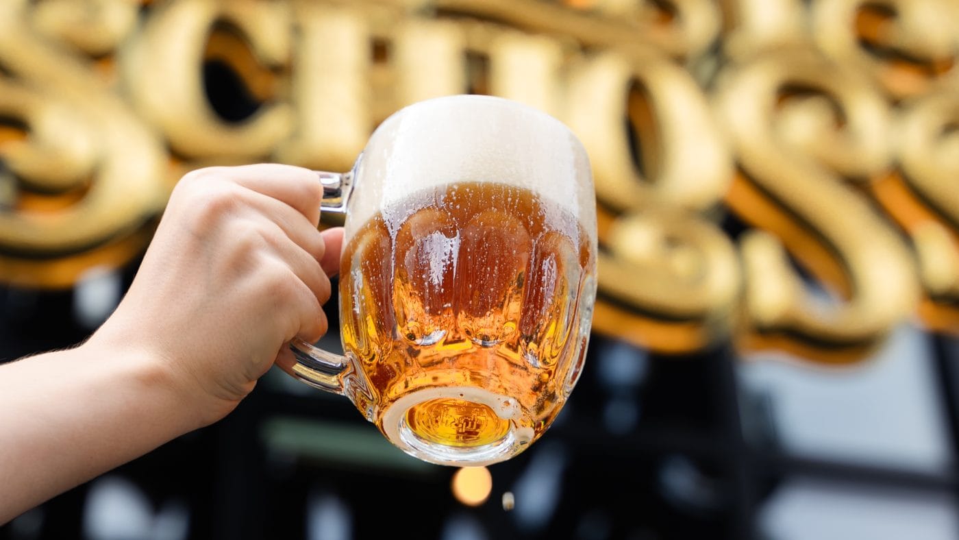 Pint of beer held up outside Albert's Schloss