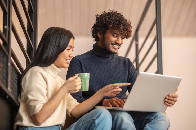 people sitting near table with laptop computer