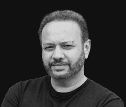 Tariq Muhammad, CEO of TITAN PMR, in a black t-shirt against a dark background