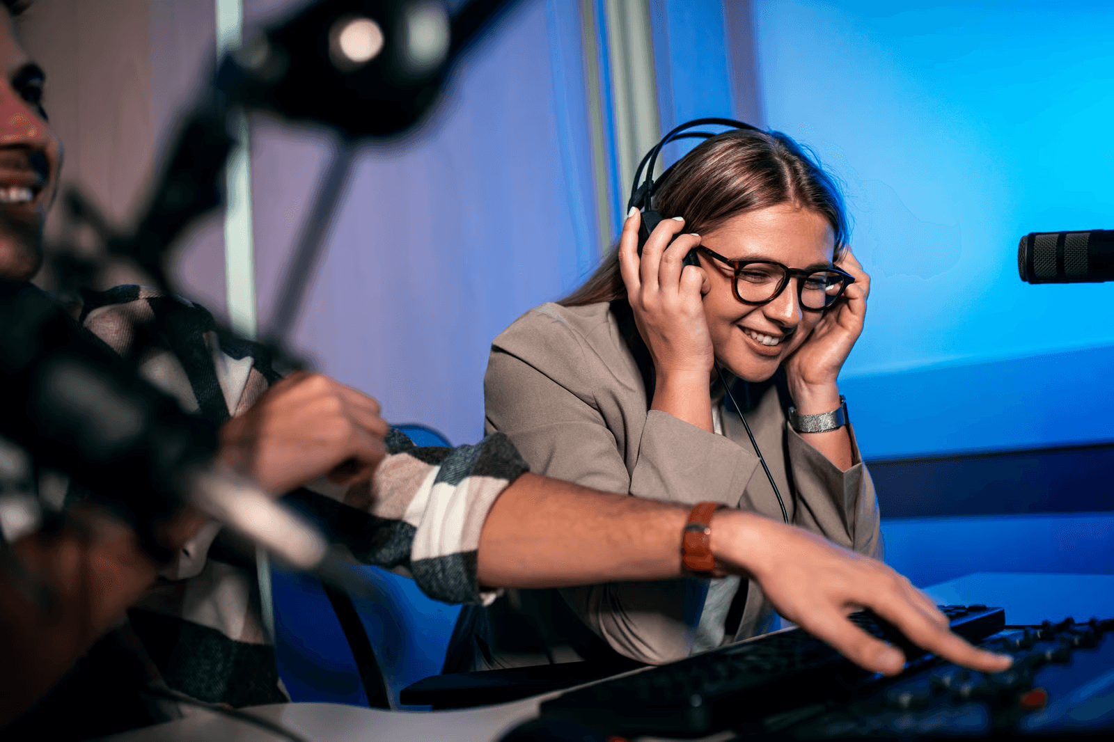 A person wearing headphones recording or hosting a podcast in a studio.