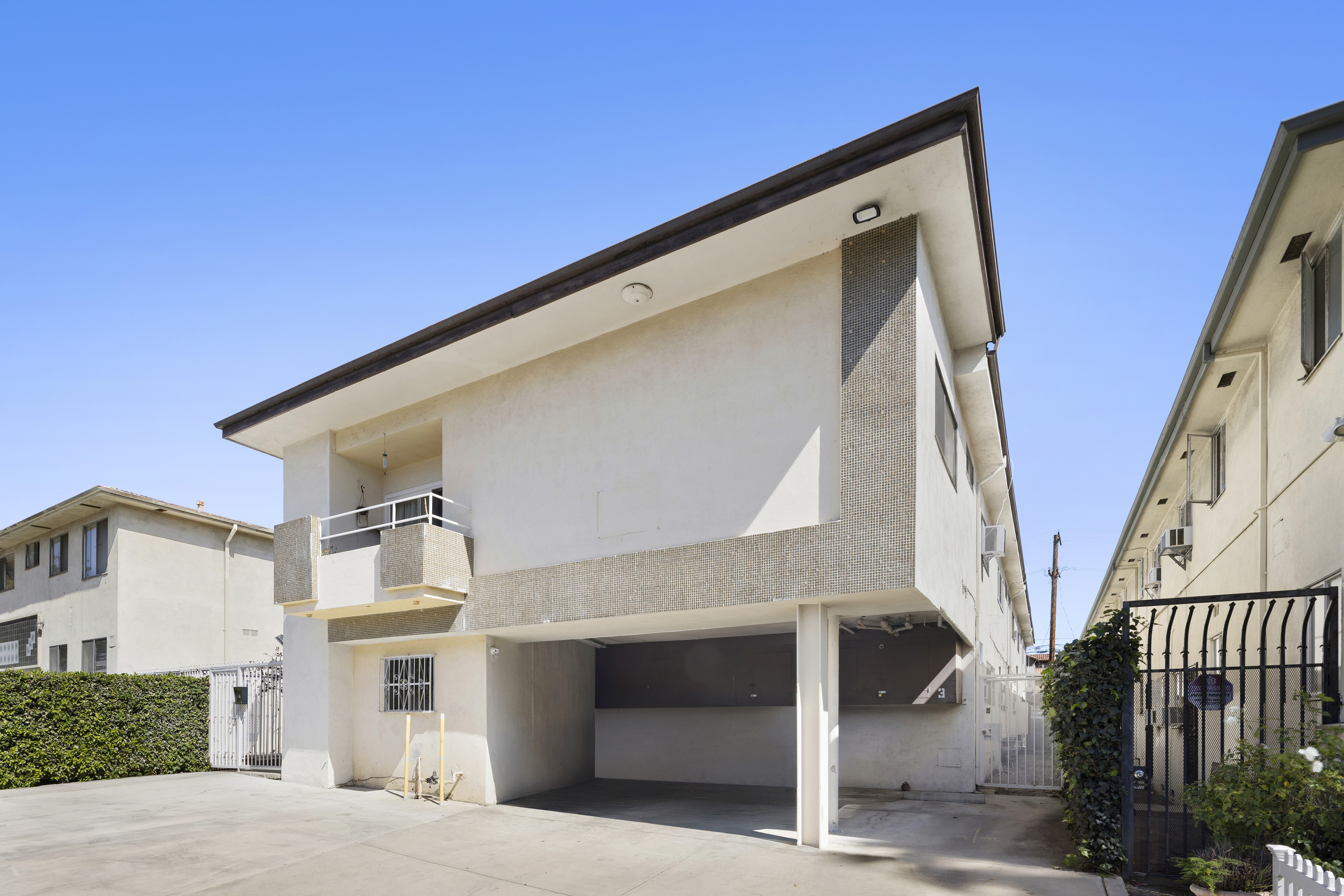 Angled exterior view showing building design and covered parking area at 1336 N Citrus Ave.
