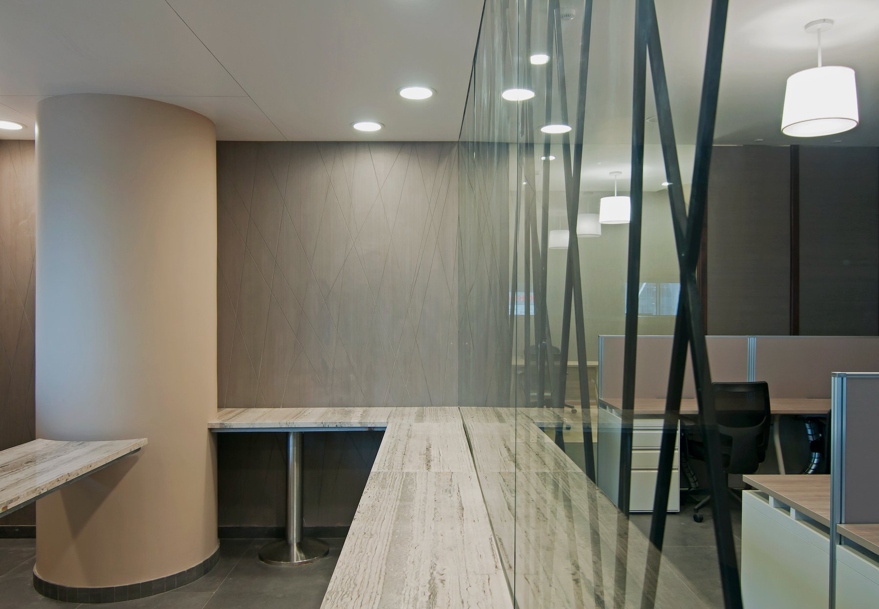 Nature-inspired preschool entrance with sculptural tree partitions and suspended green leaf ceiling panels.
