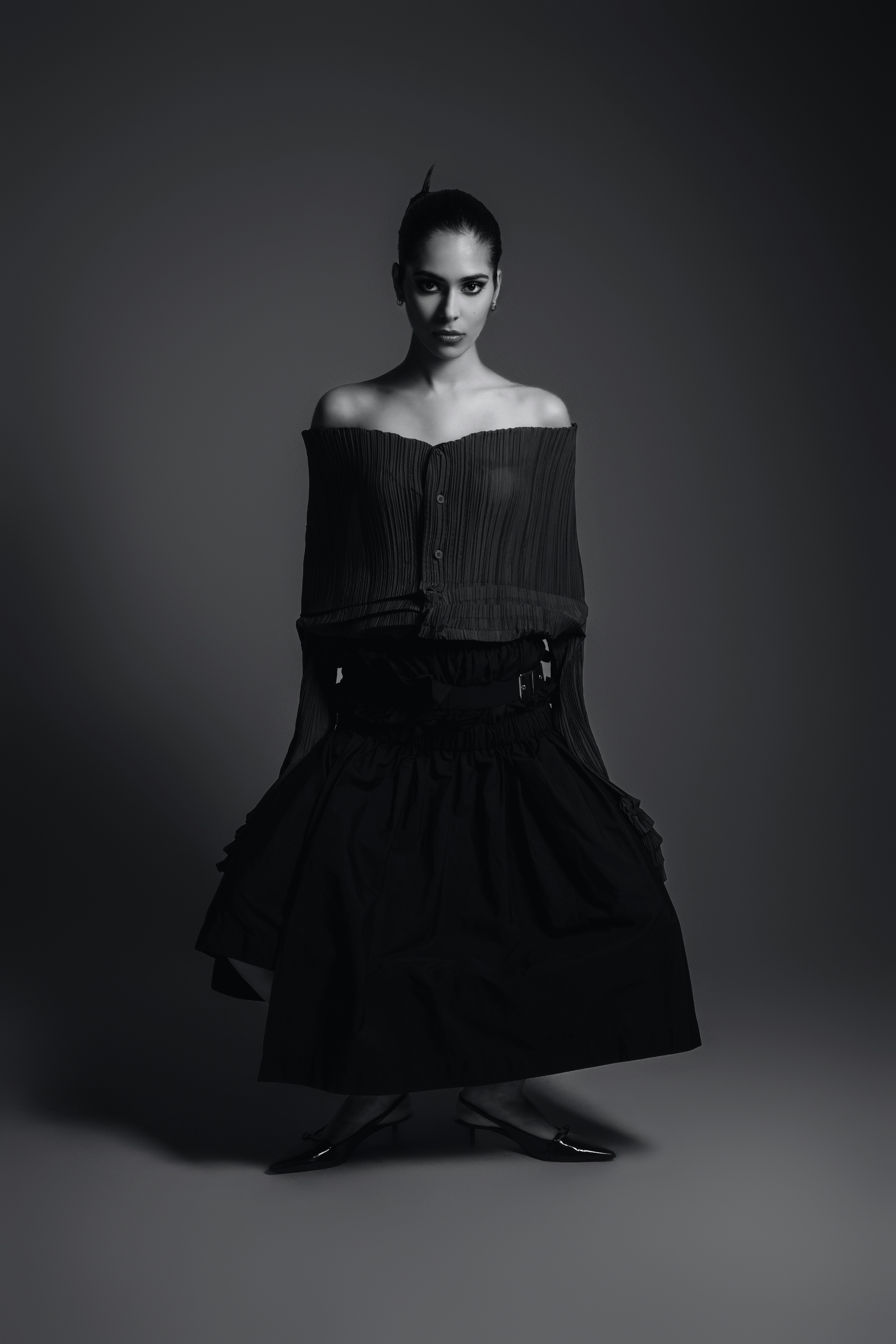 A black and white photo of a woman in a dress