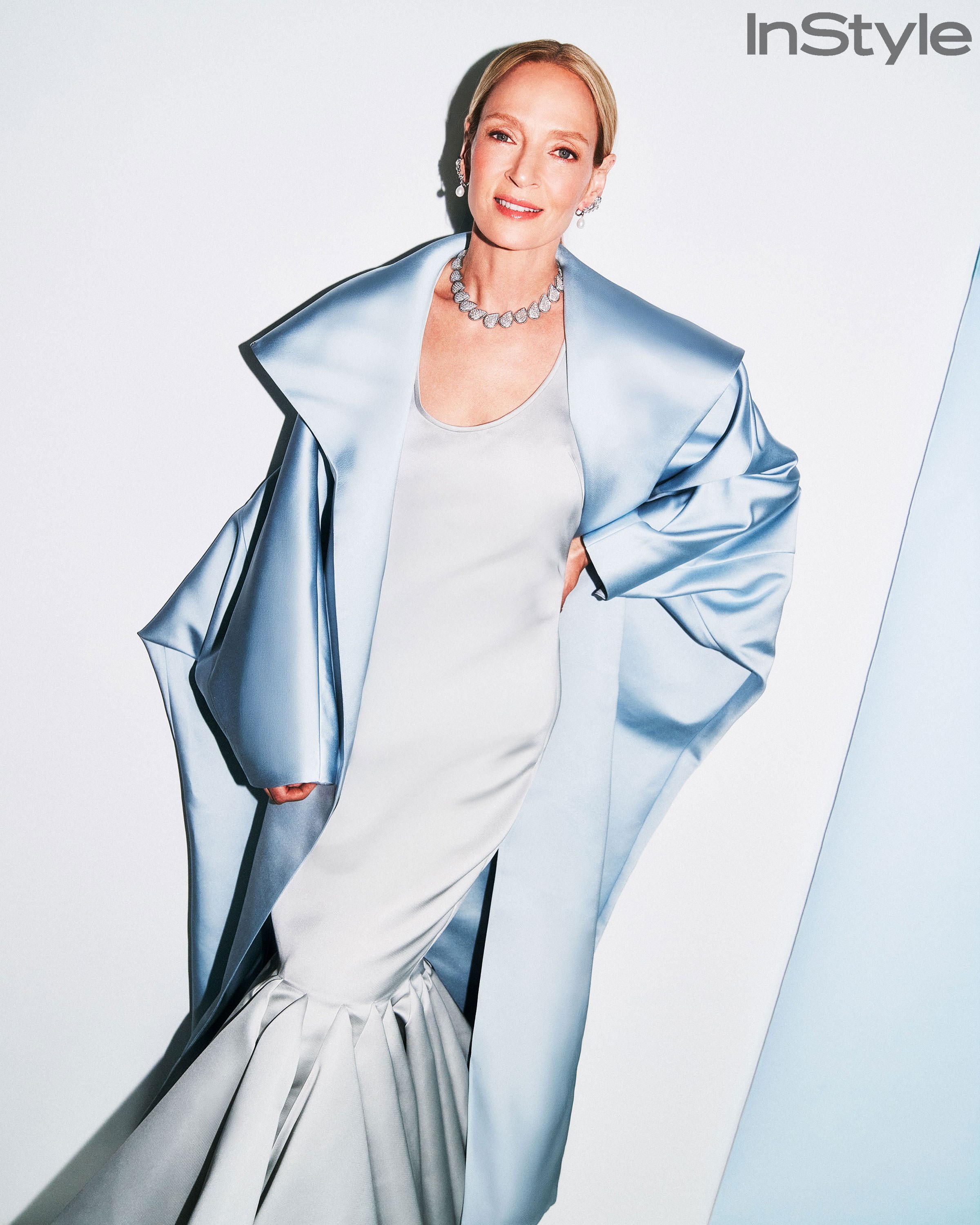 Uma Thurman in a sculptural silver couture look against an angular pale set