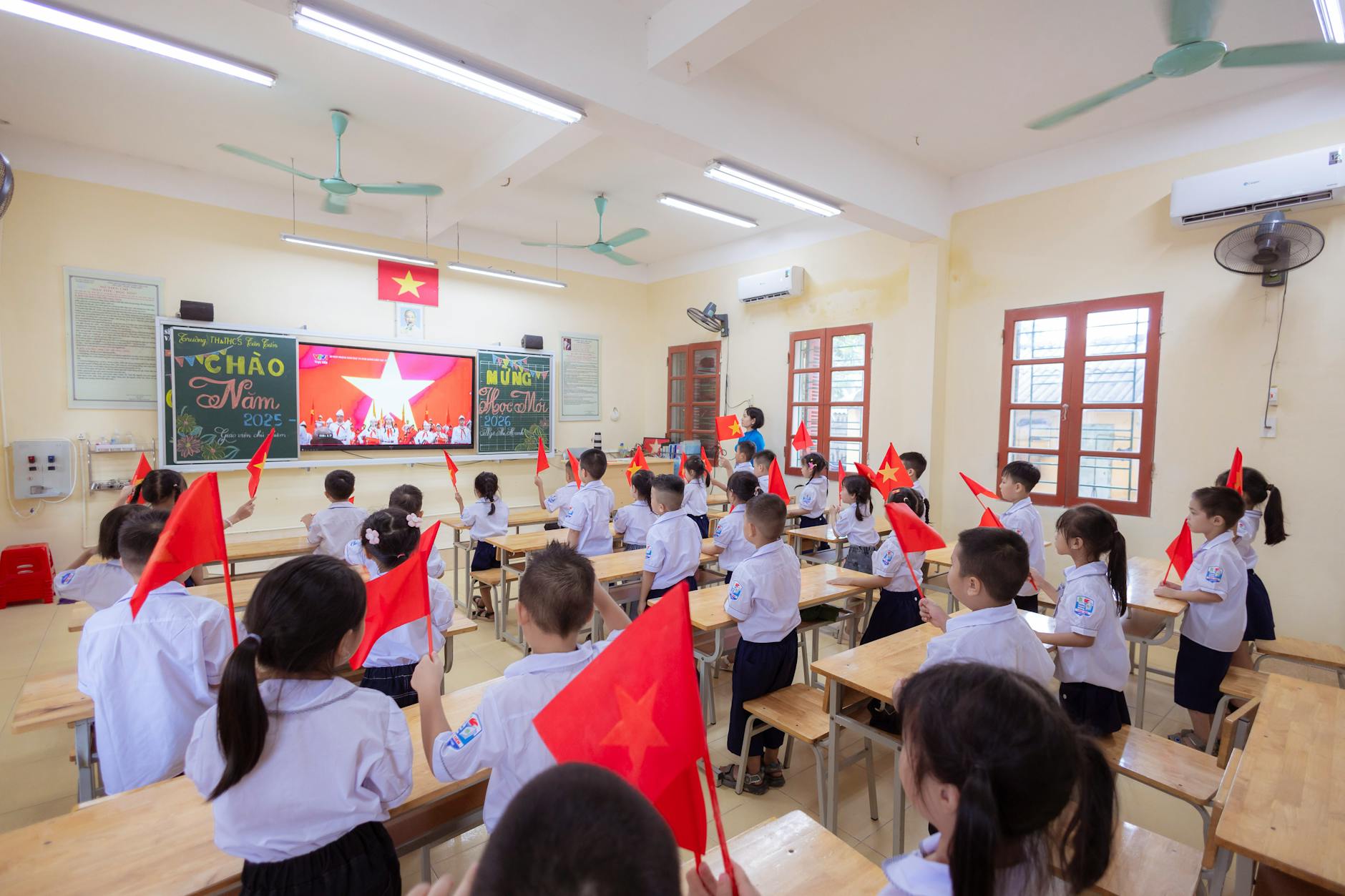 A diverse group of children sharing traditional snacks and crafts from different cultures at a decorated table.