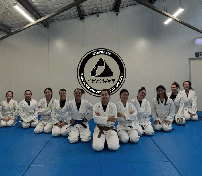 Large group of students in gis posing for a team photo on the mats