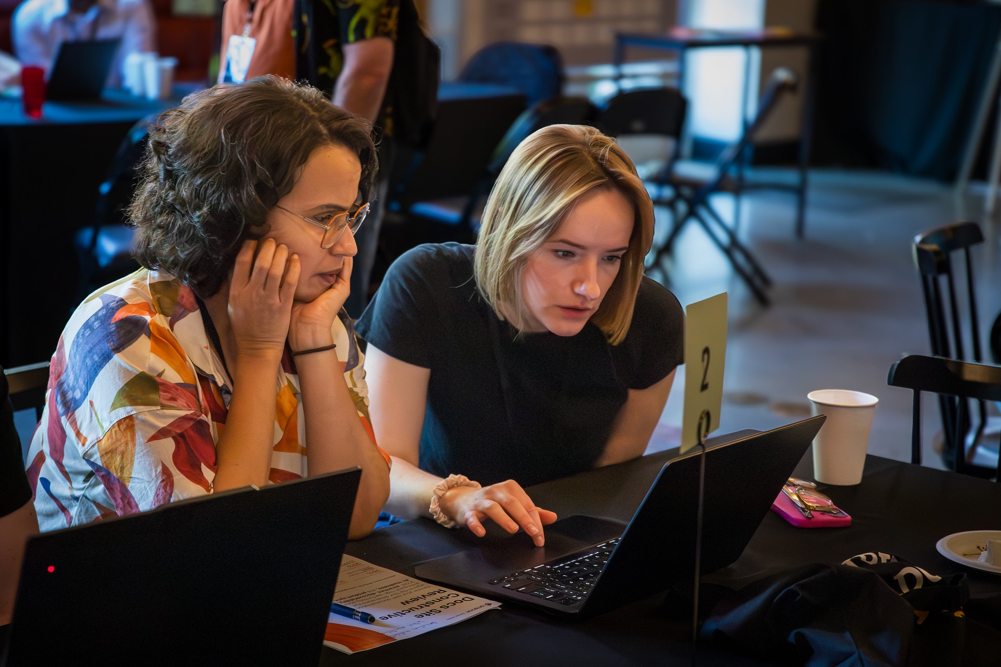 A photograph of Sarah helping an attendee’s during a working session at WTD Portland 2026