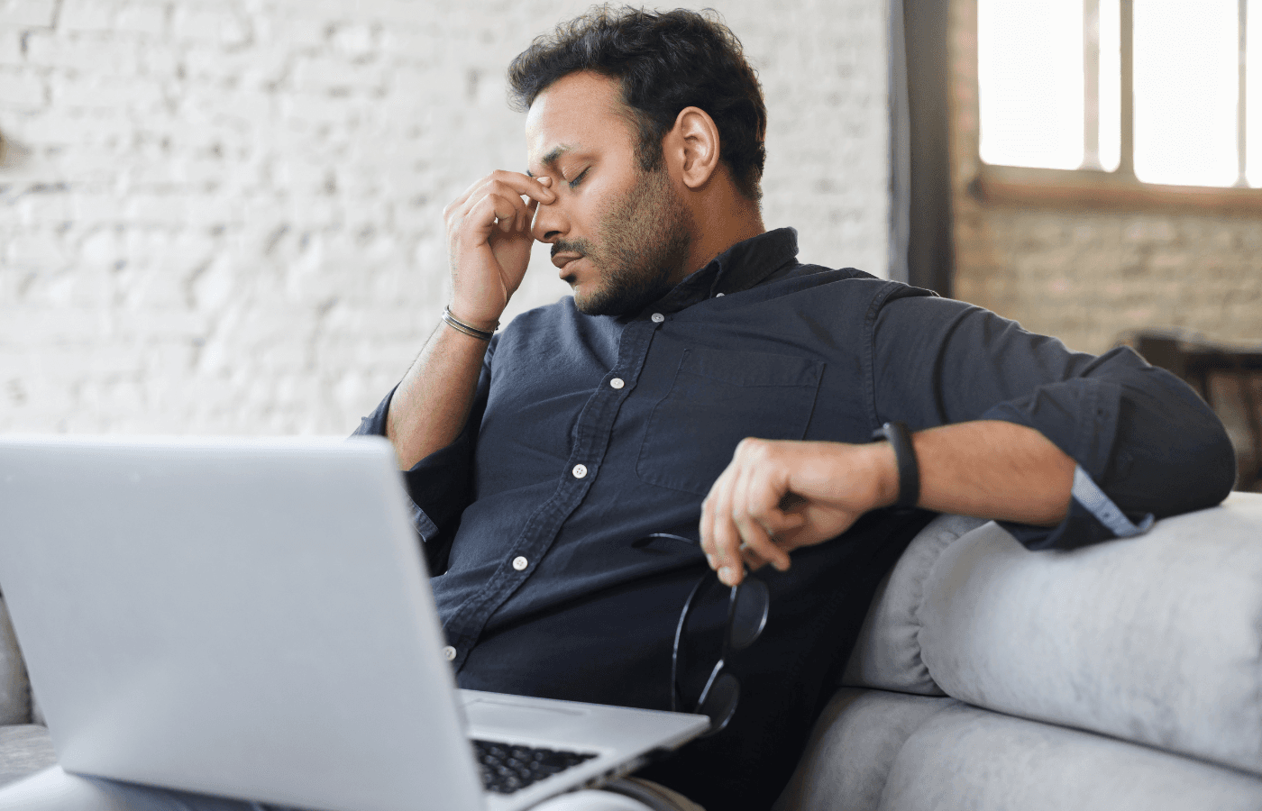 tired-looking man using computer