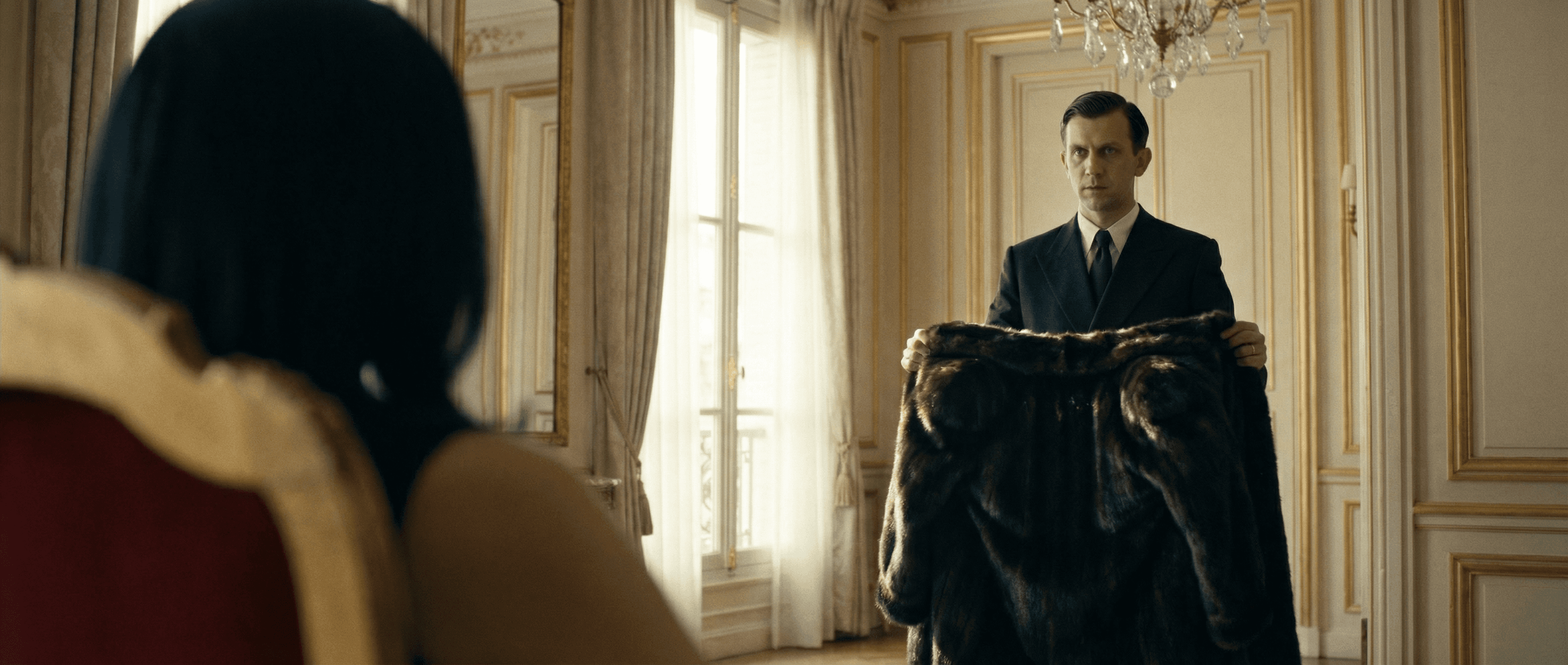 Man presenting a coat in a salon