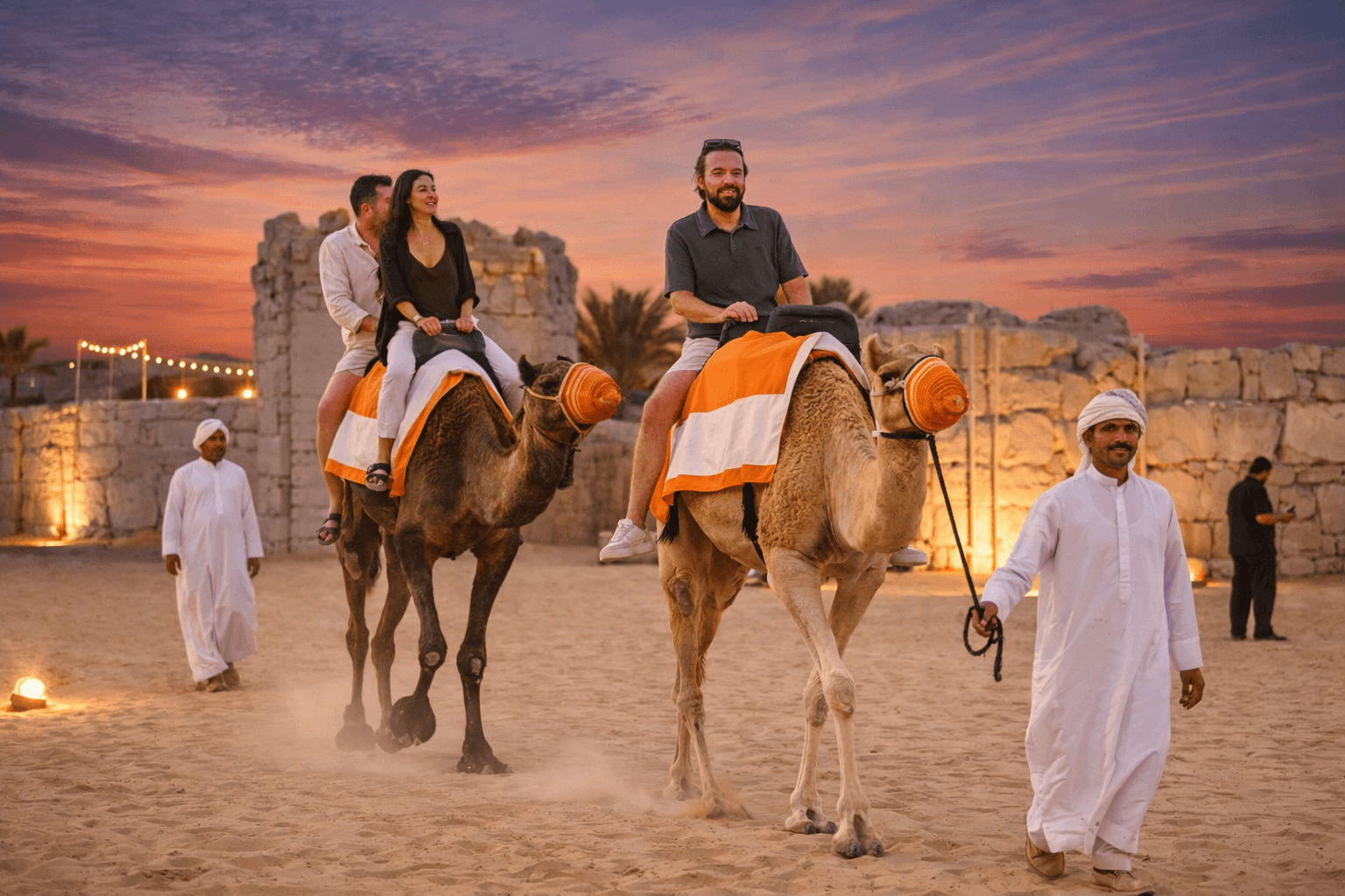Guests riding camels at The Fort Lisaili during the Dune Quest Tours VIP evening desert safari experience in Dubai