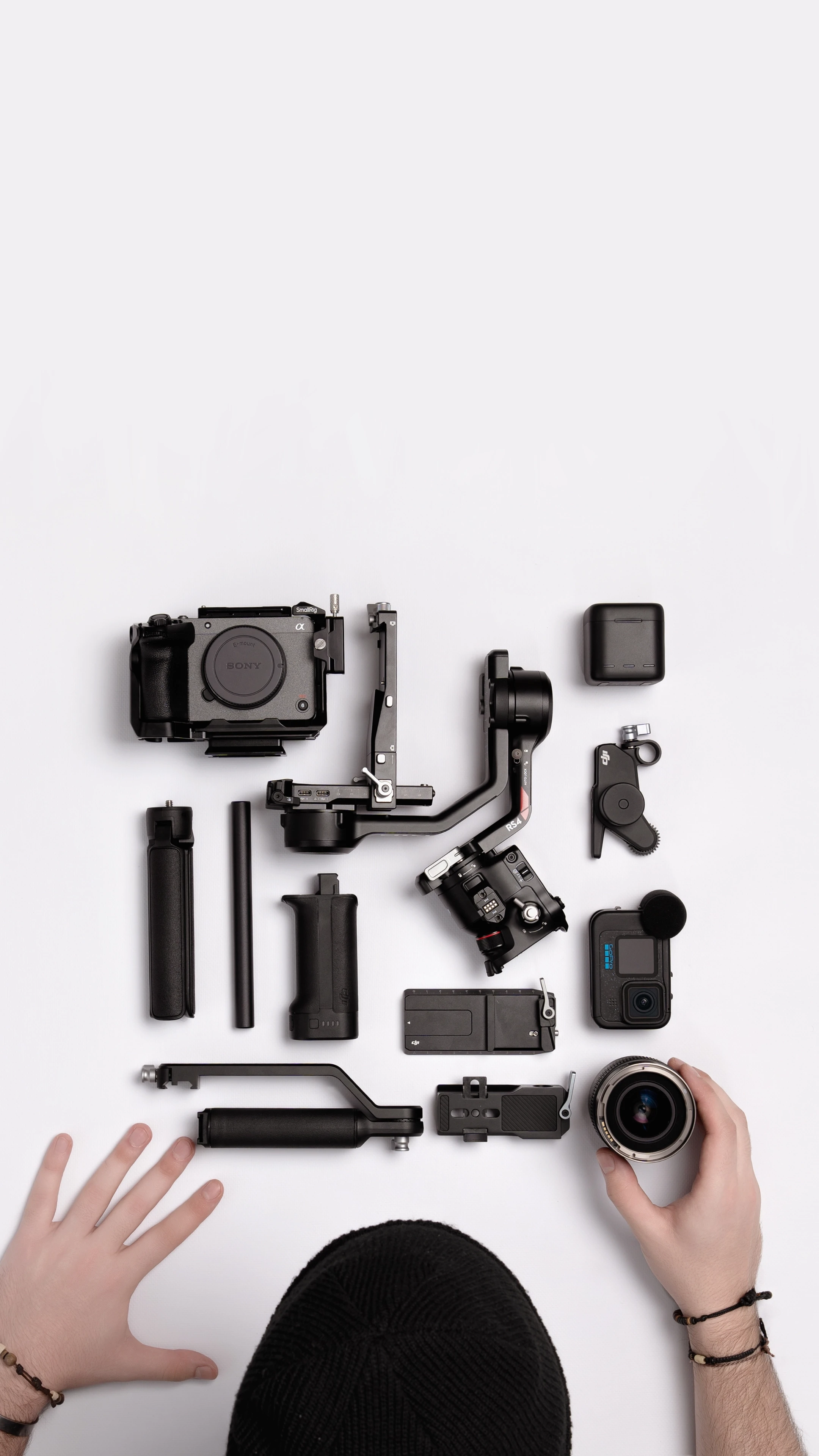 Close-up of videography setup on a desk featuring camera gear and stabiliser alongside documents, representing Raybrand Media’s professional video production workflow, content creation process and creative studio environment