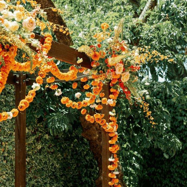 Wooden arch with marigold flower garlands
