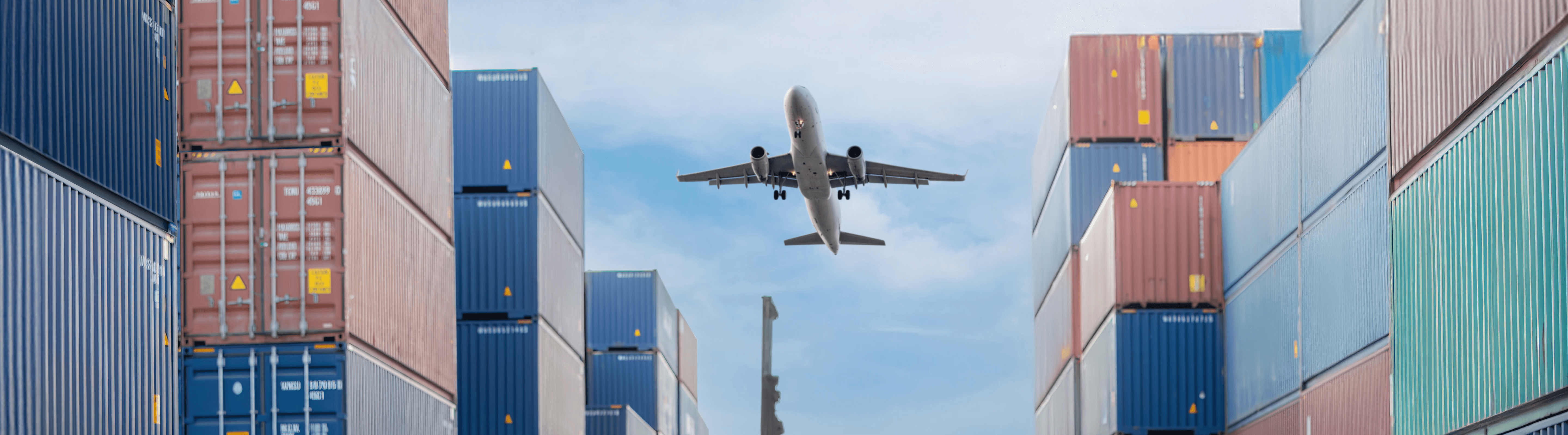 Plane flying over crates of containers