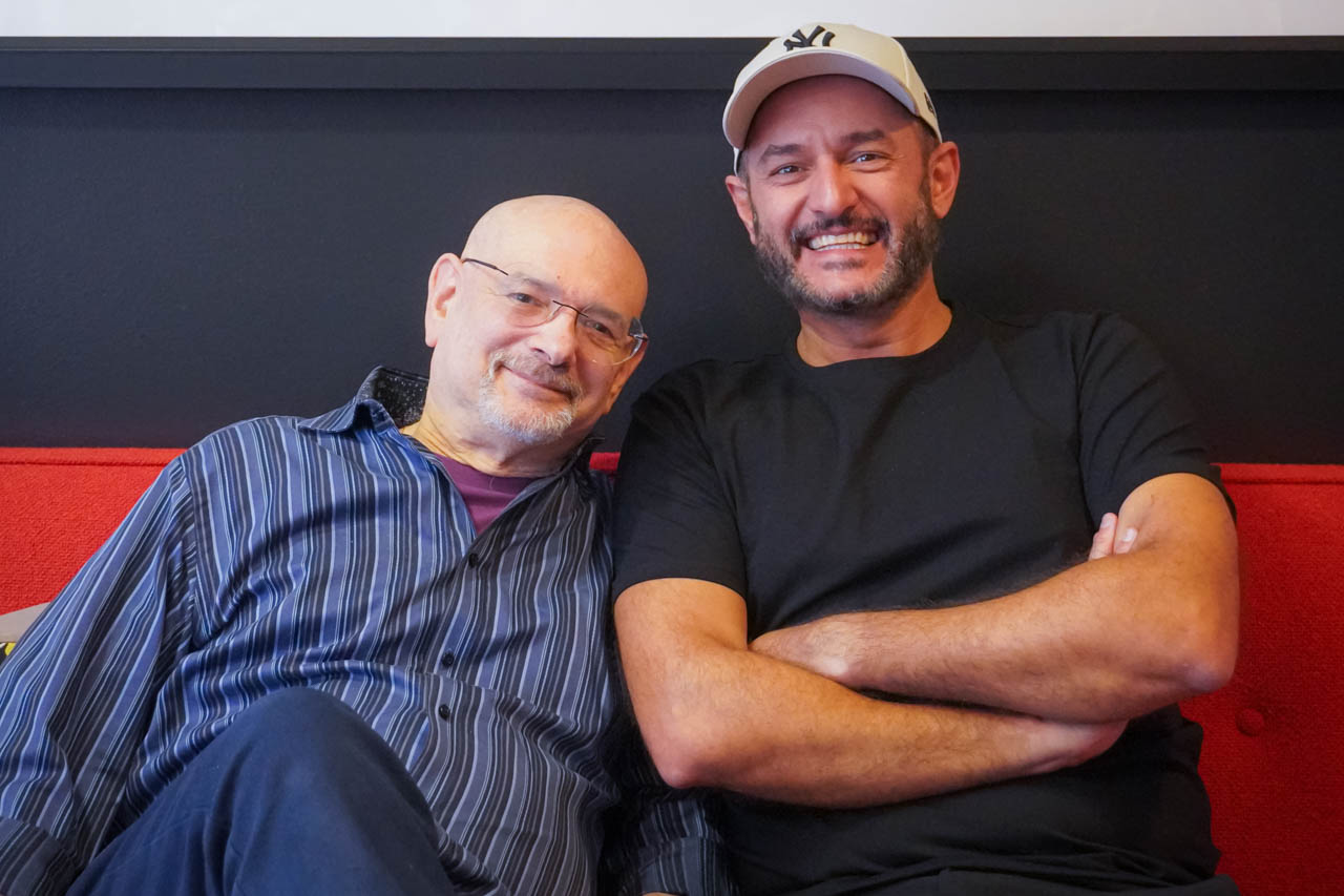two men sitting on a couch