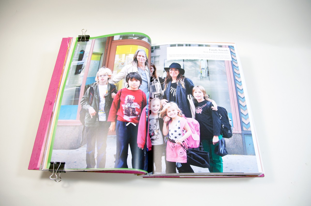 an opened book depicting a group photo printed on both pages left to right
