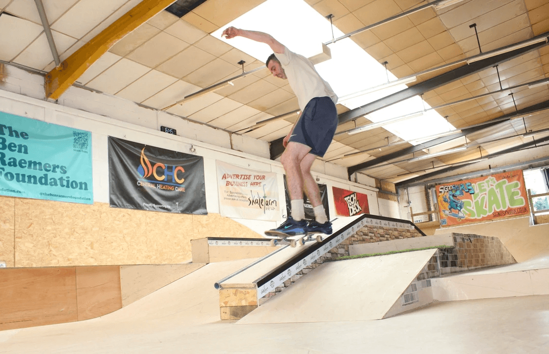 An adult learning to skateboard at The Skate Farm indoor skatepark in Haywards Heath, Sussex