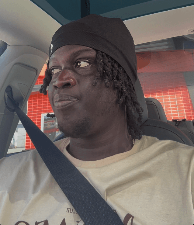 man standing beside wall