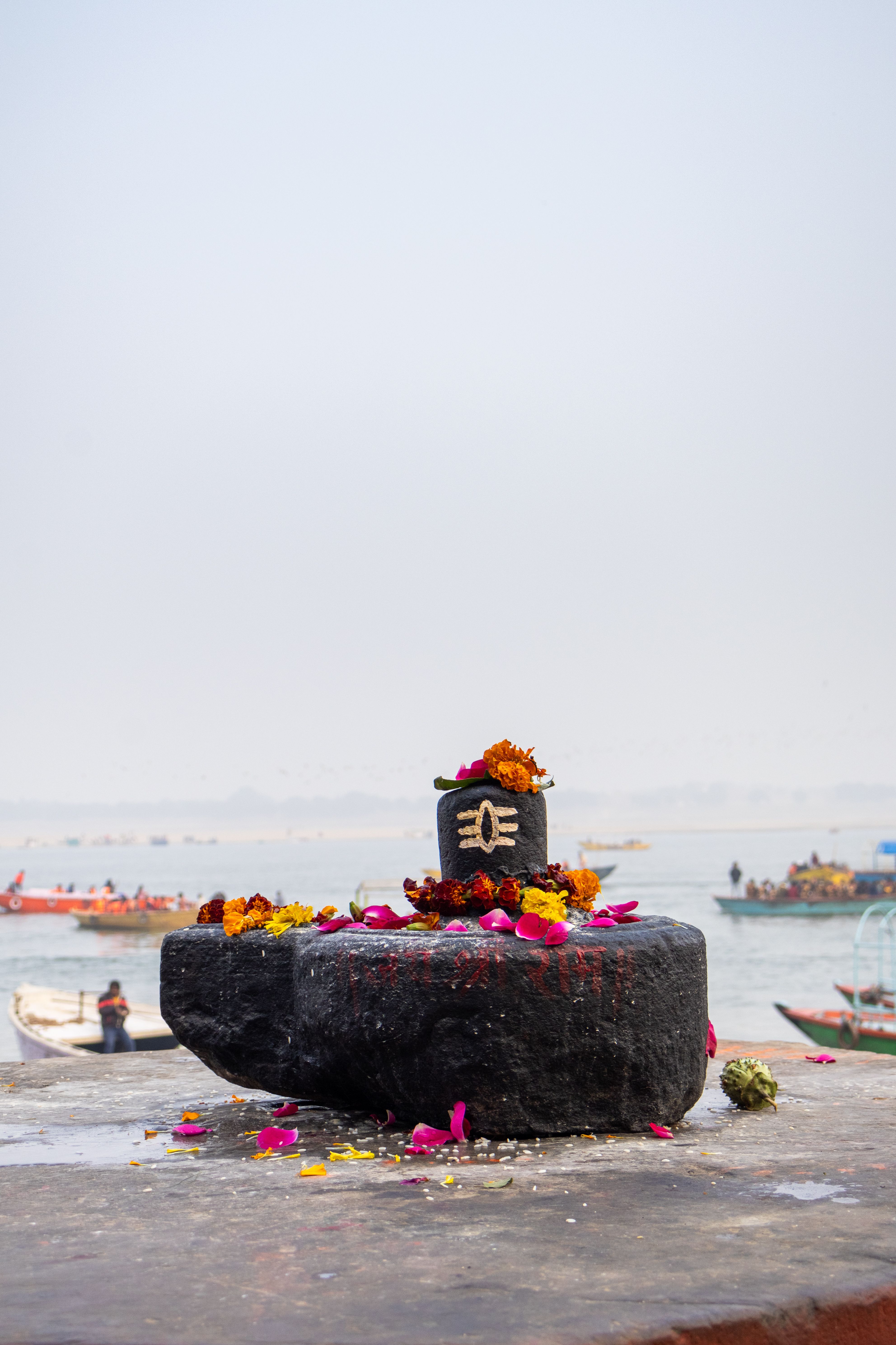 A decorated boat sitting by the water with various decorations.