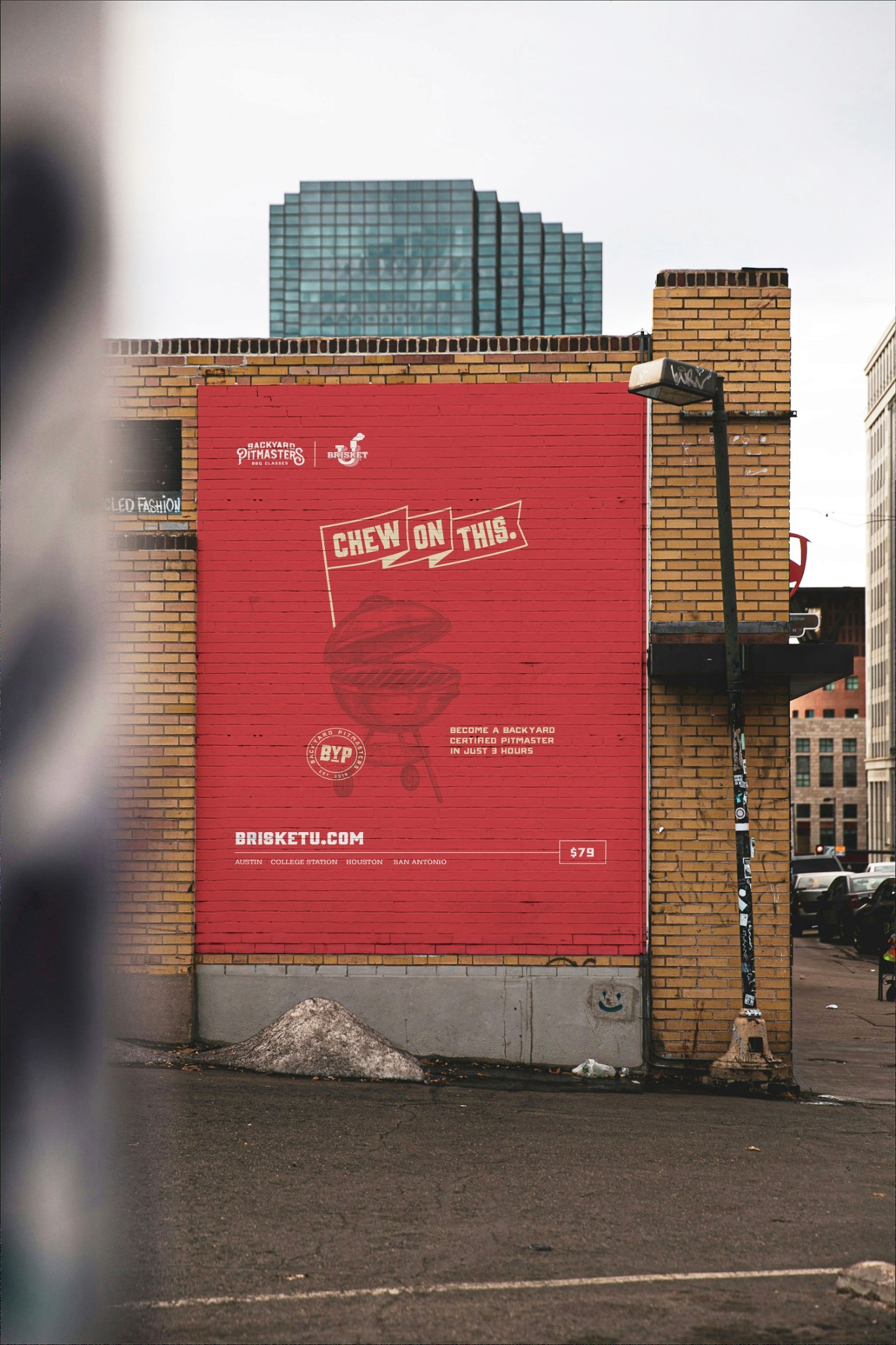 Red outdoor poster on a brick wall in a city