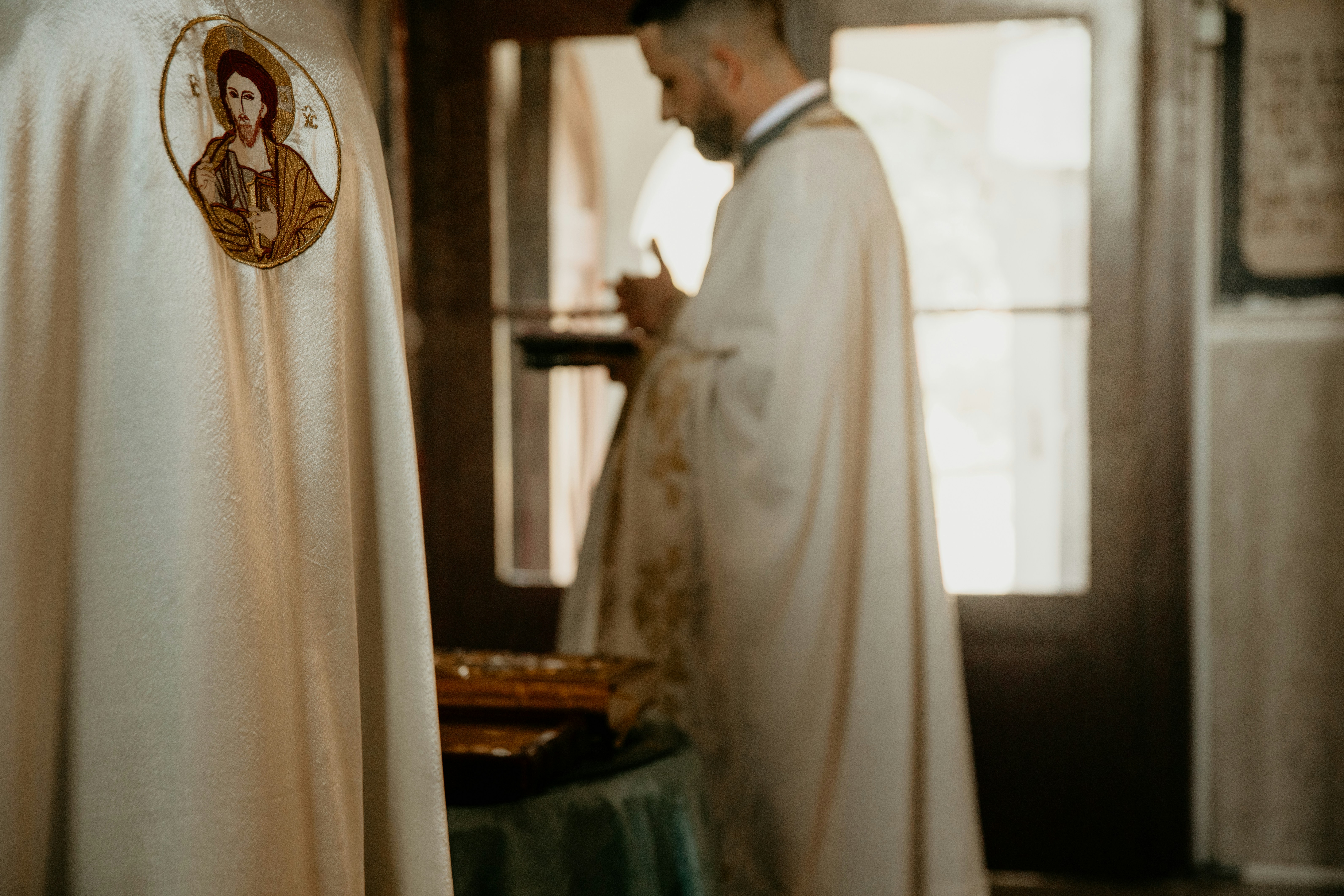 person sitting on grass and using phone