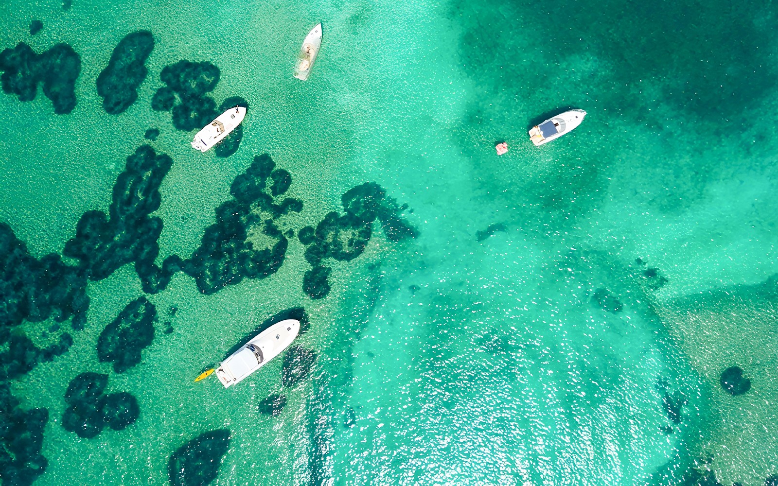 Boats on turquoise waters near Elaphiti Islands, Dubrovnik, during a Blue Cave tour.