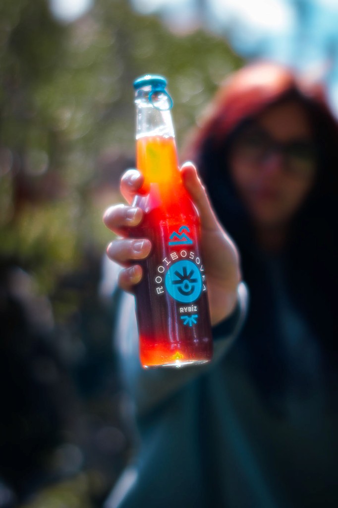 a woman holding a red flower