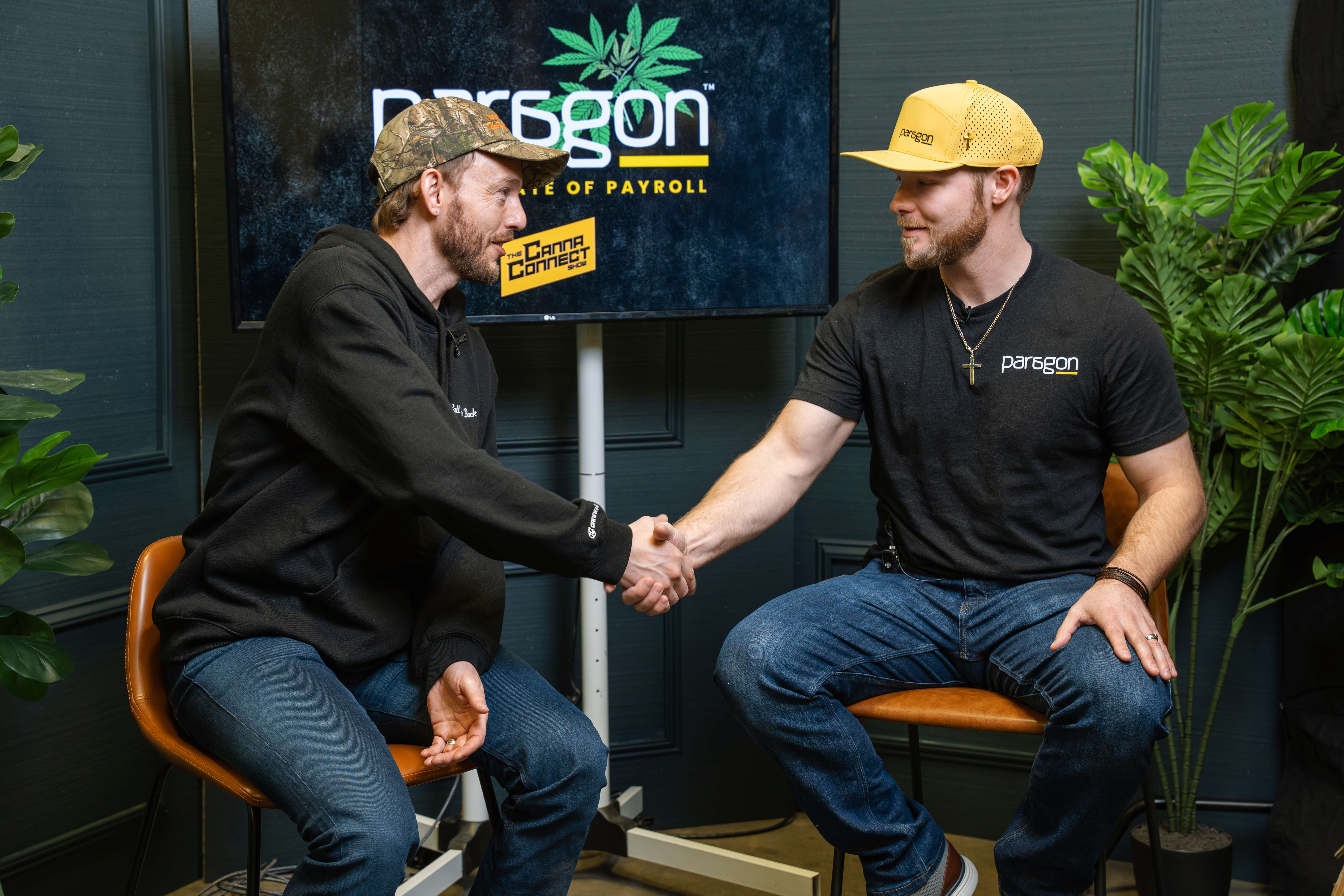 Stephen Eigenmann shaking hands with Shawn Worth on The Canna Connect Show live from Lucky Leaf Expo 2026