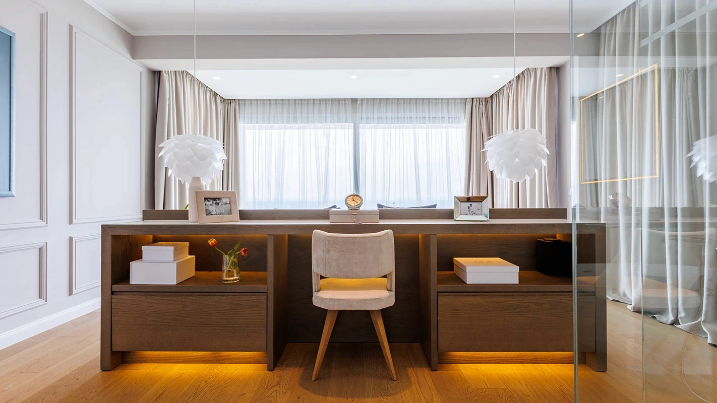 Seafront Residence Limassol bespoke dressing table vignette with symmetrical storage, warm underlighting, and sculptural pendant lamps