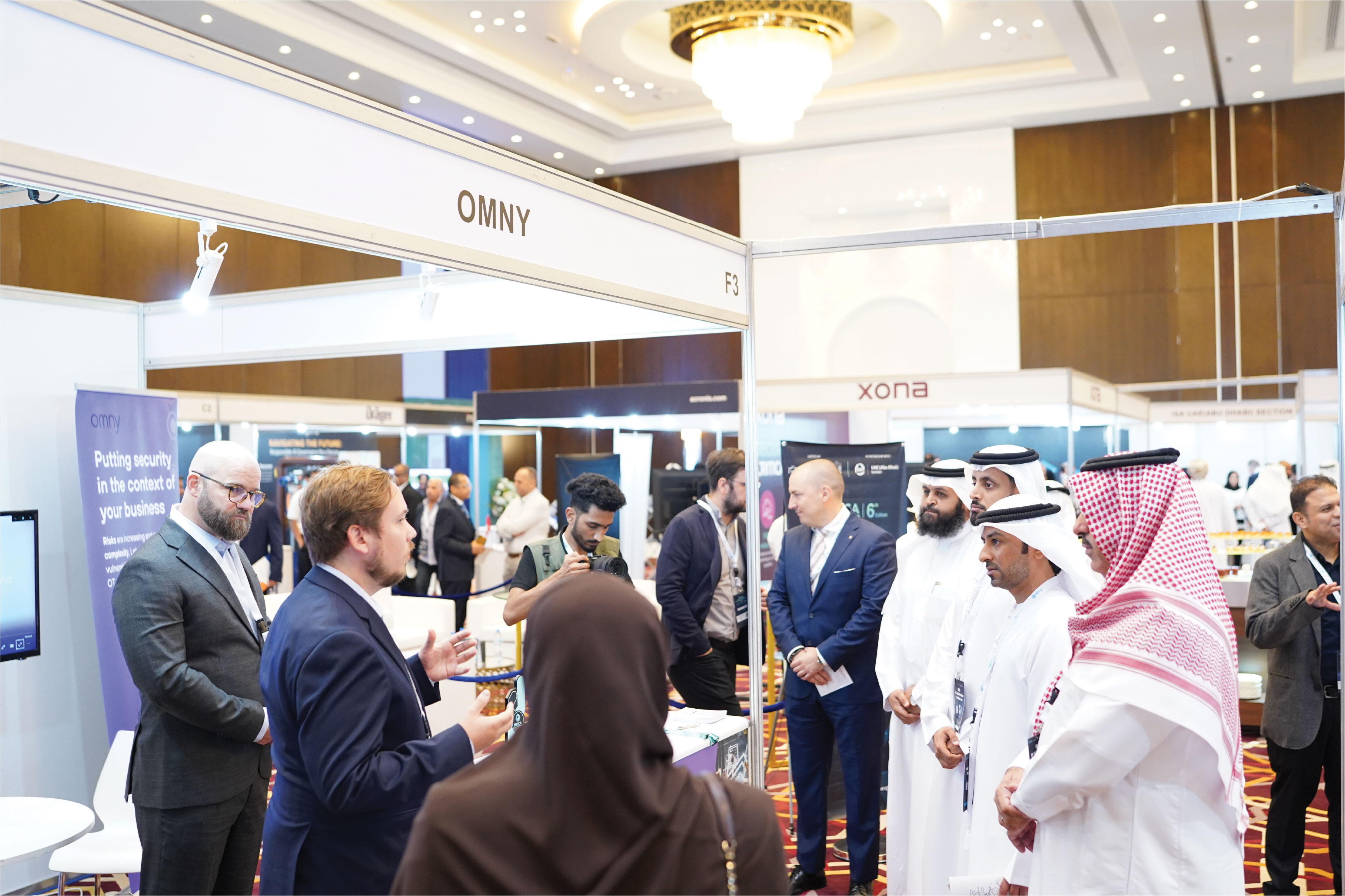 Young man in asks a question into a conference mic.