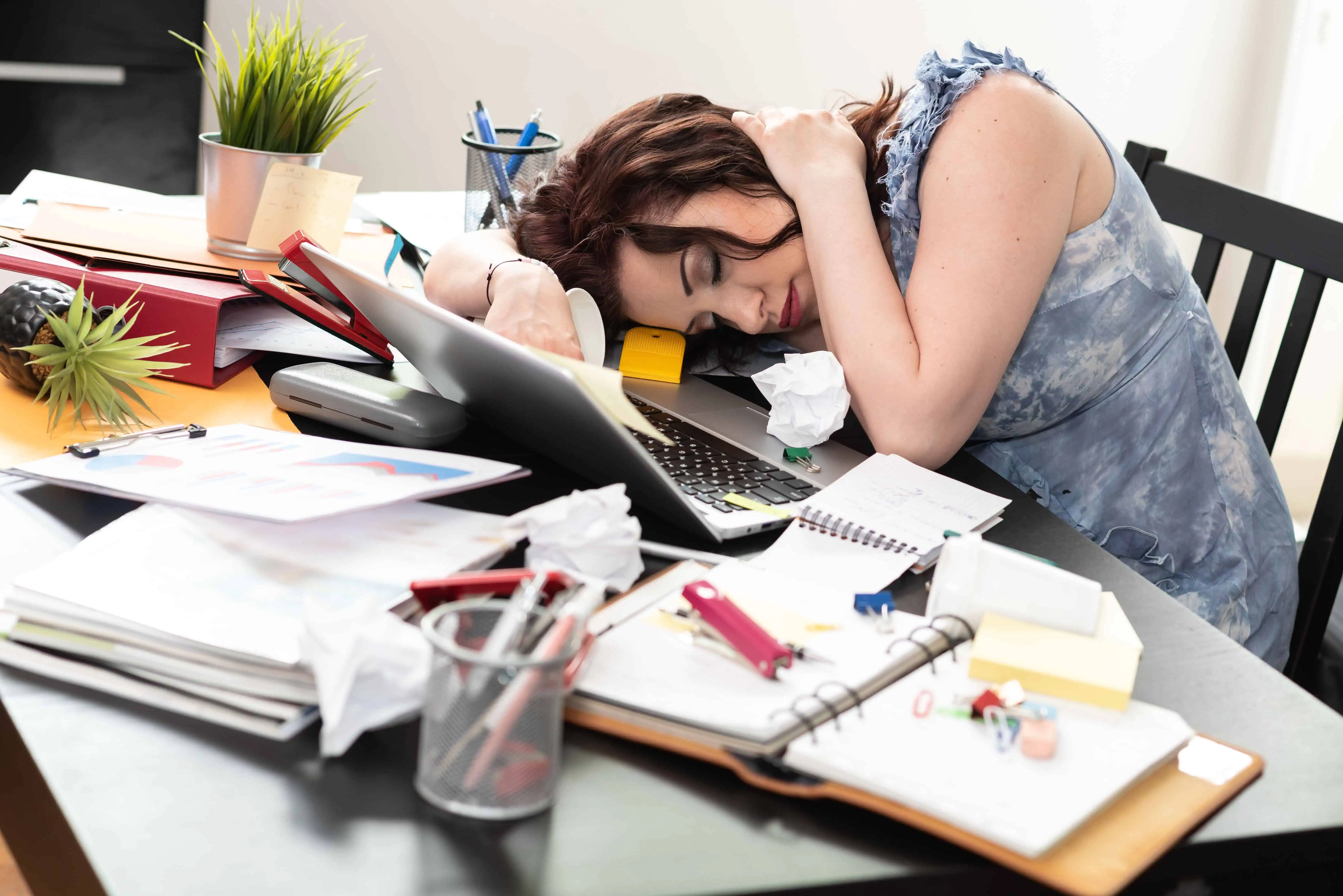 Overwhelmed business owner struggling with scattered customer data before implementing CRM system, surrounded by sticky notes and spreadsheets