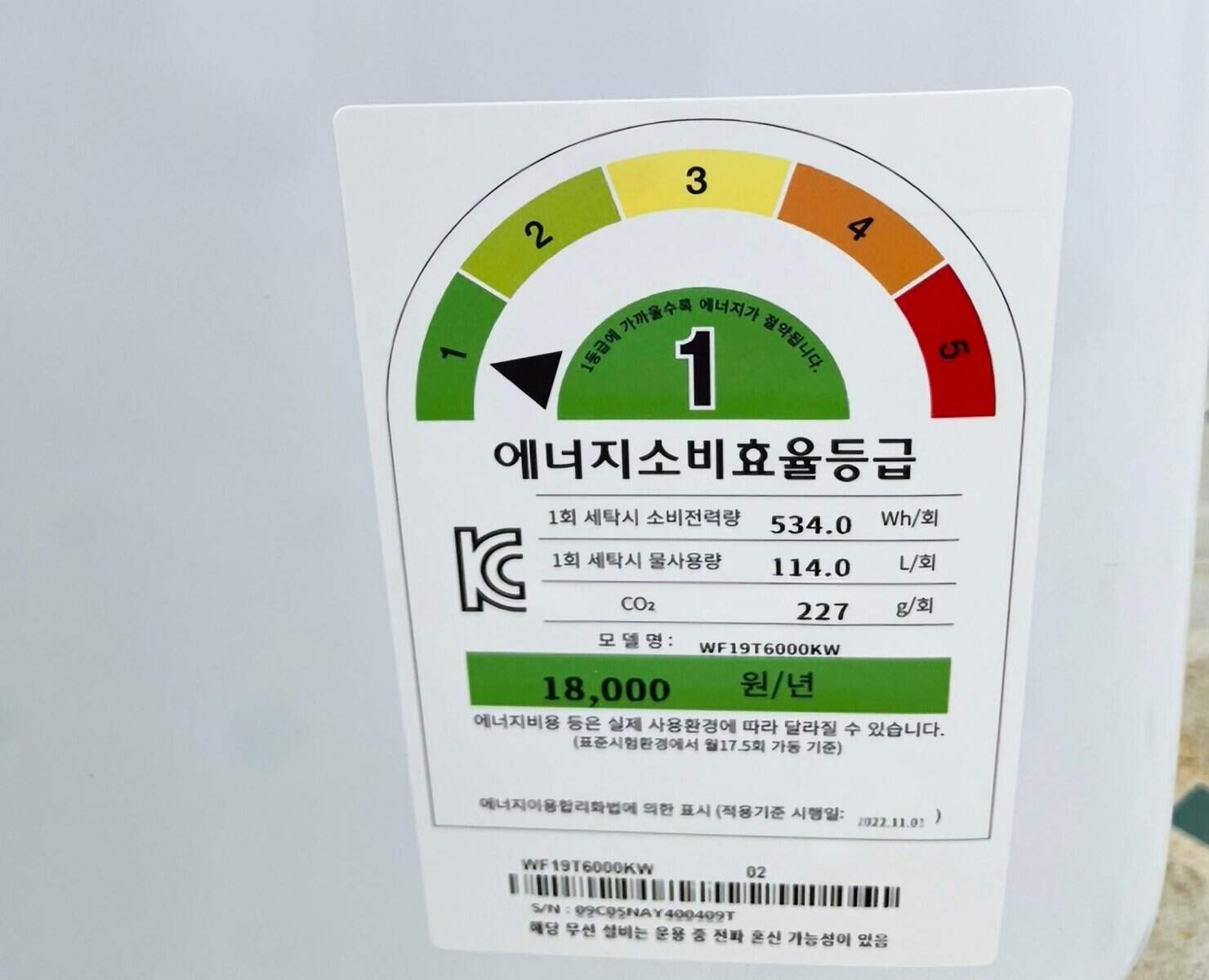 Ảnh chụp một sticker chứng nhận tiết kiệm năng lượng trên máy giặt Samsung với chứng nhận sản phẩm Hàn Quốc cấp 1 về tiết kiệm điện năng (màu xanh lá).