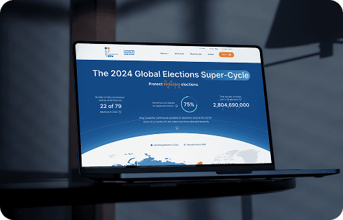 Sandy dunes with misty ocean and distant hills.