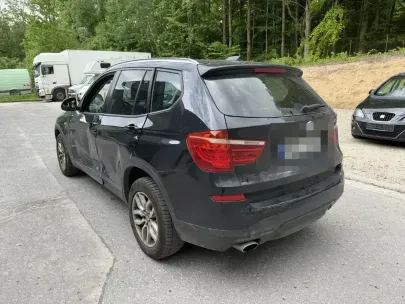 black car from behind. picture of a damaged door of an bmw.