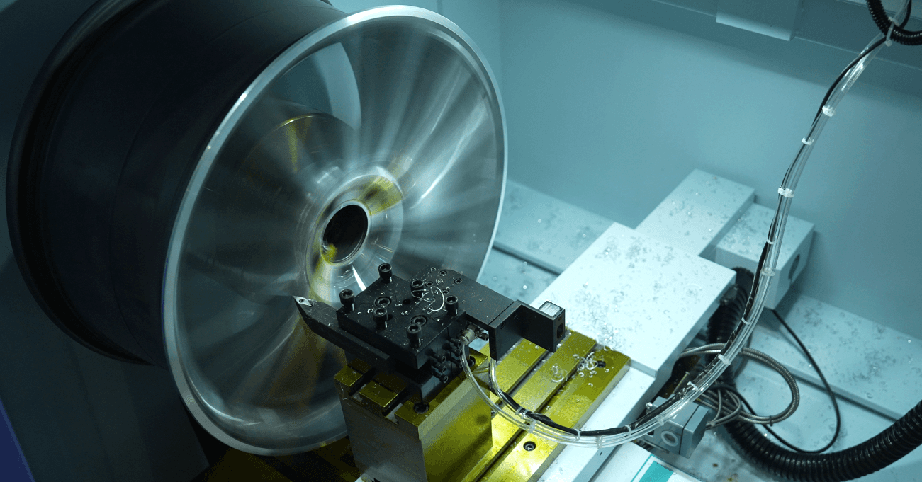 Modern indoor space with large glass doors, lush greenery, and a cozy seating area visible beyond.