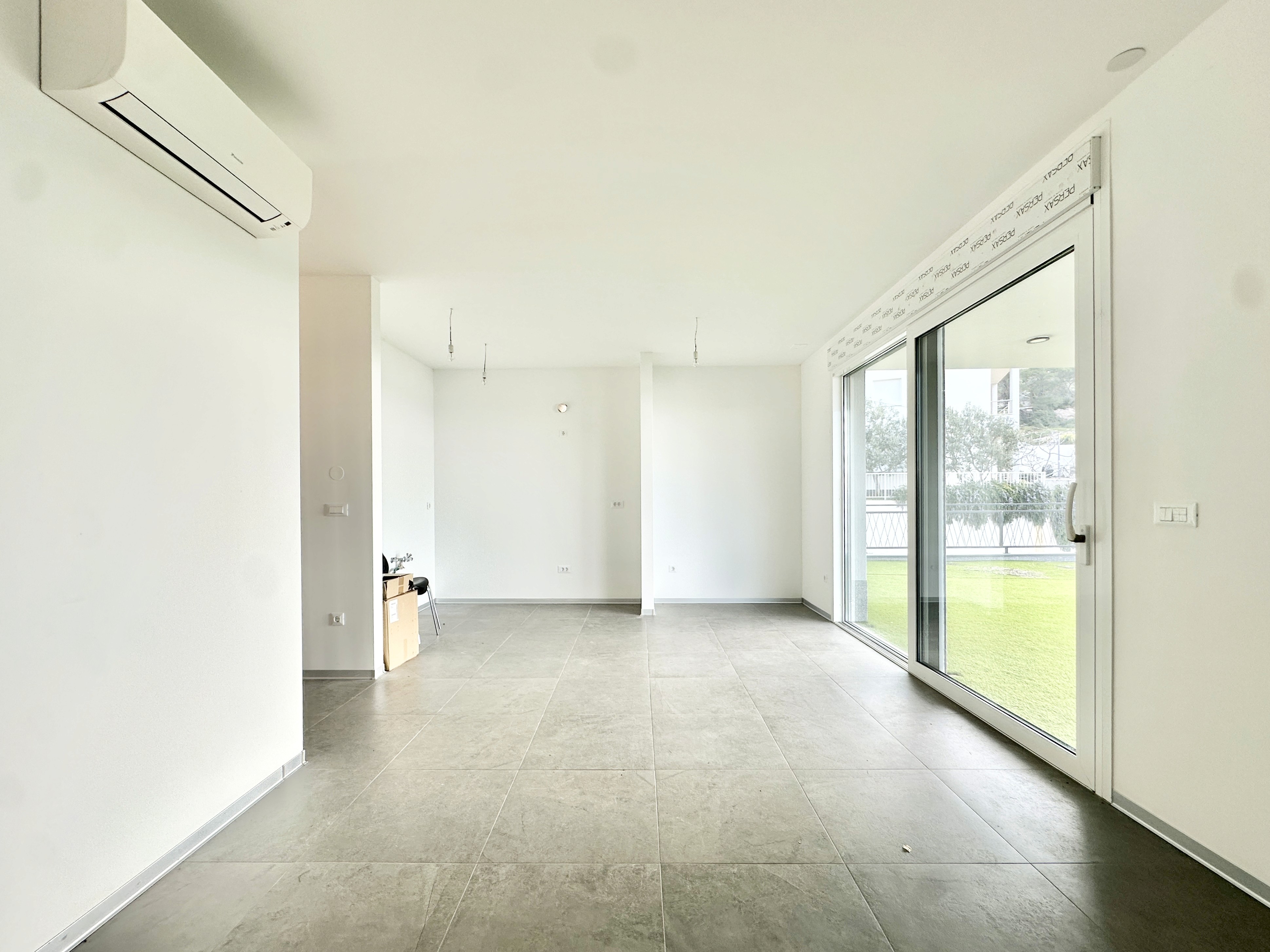 Black sports car in front of a modern, futuristic curved building.