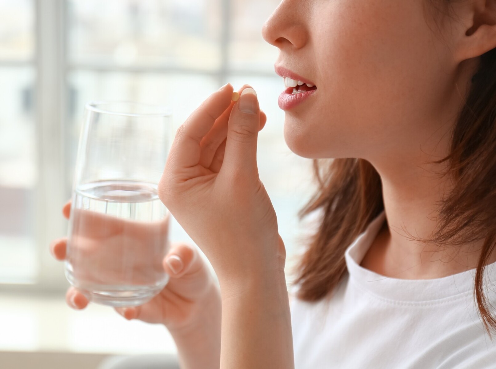 woman taking what she thinks is the best over-the-counter weight loss supplement