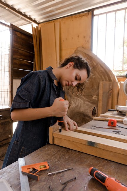millwork shop manager reviewing production schedule on a tablet, illustrating real-time tracking