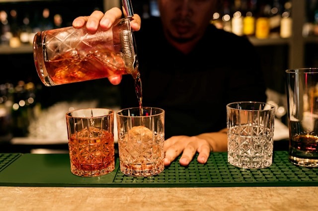 Bartender pouring old fashioned cocktails