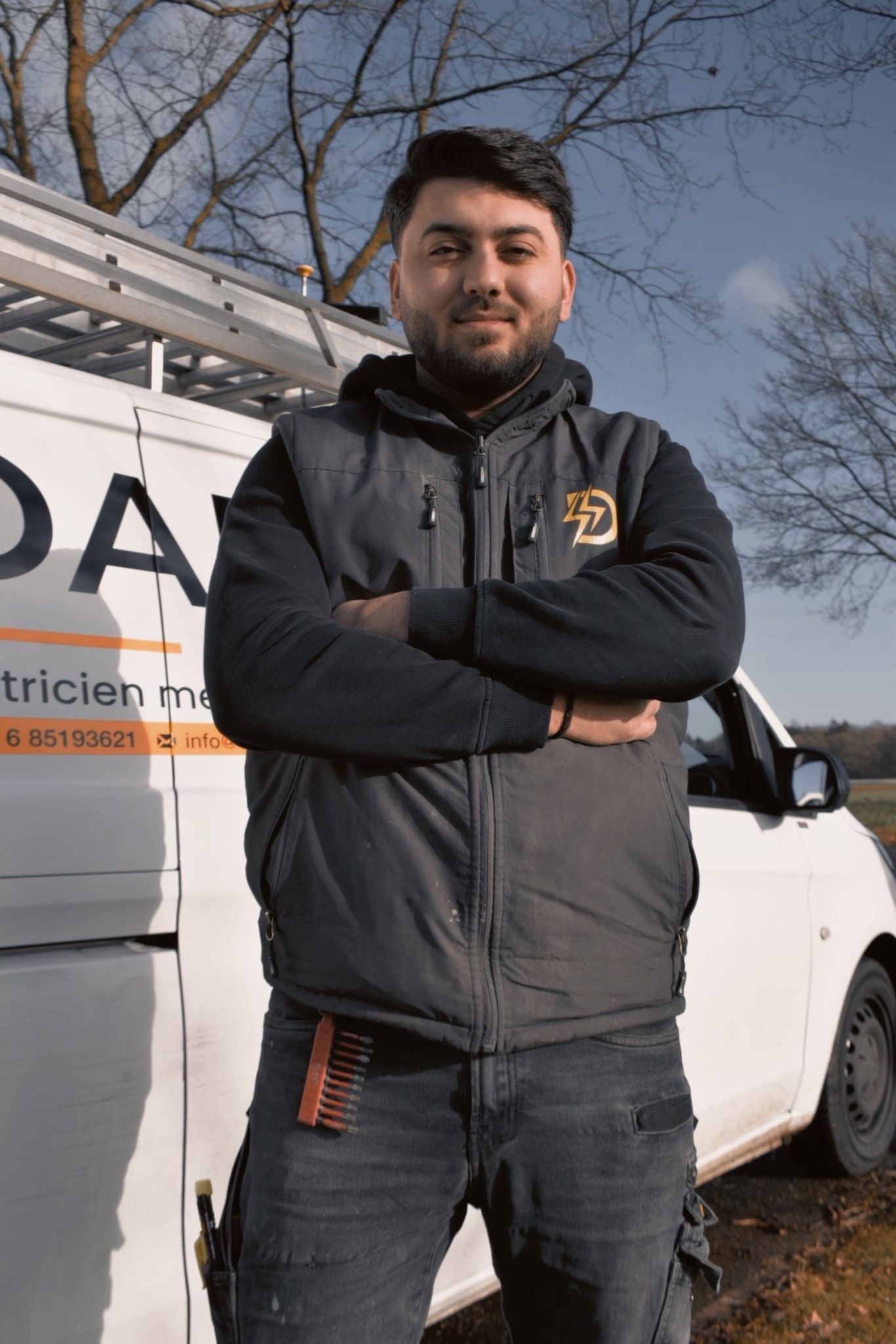 Modern urban architecture with illuminated glass buildings and trees on a rainy day