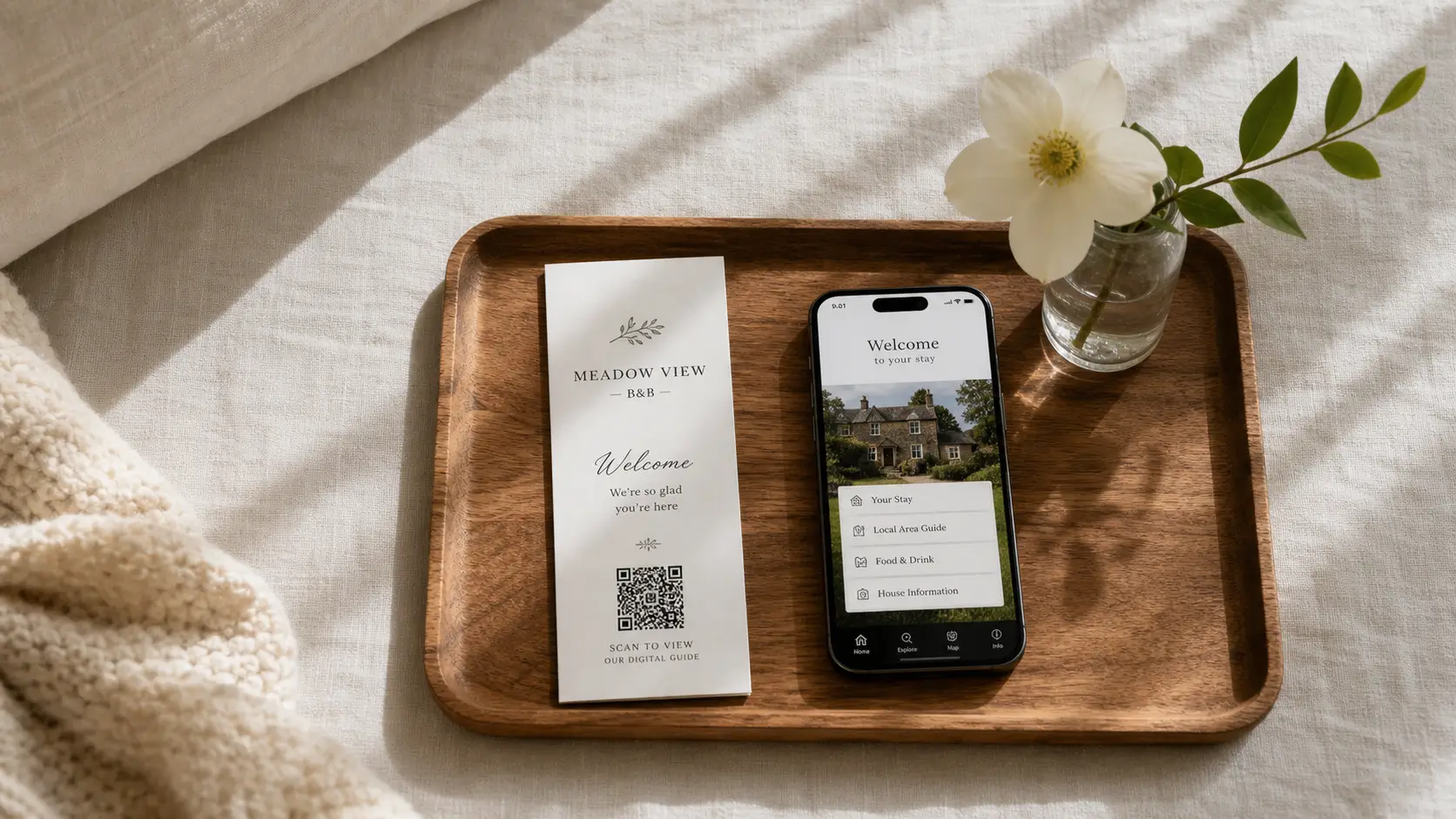 B&B welcome card with QR code beside a phone showing the digital guide.