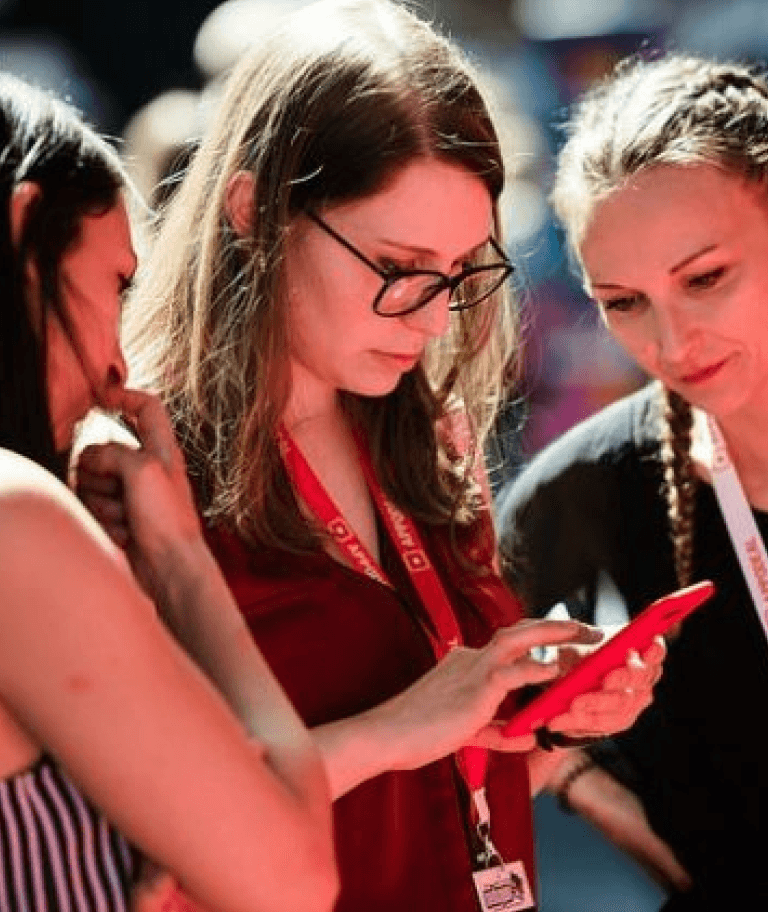 A woman looking at her phone at an event