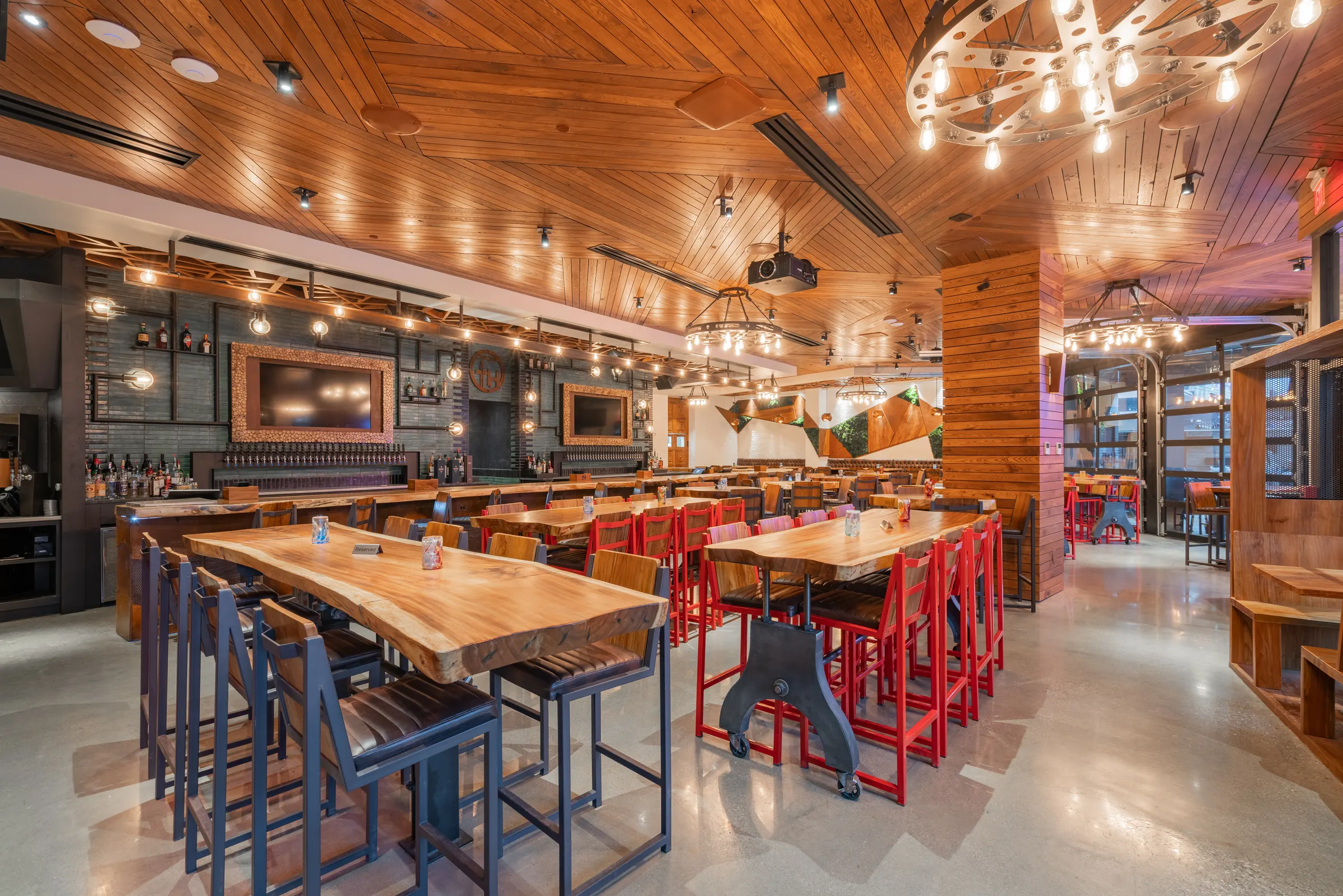 Dining room with long wood tables and red chairs at TownHall Columbus